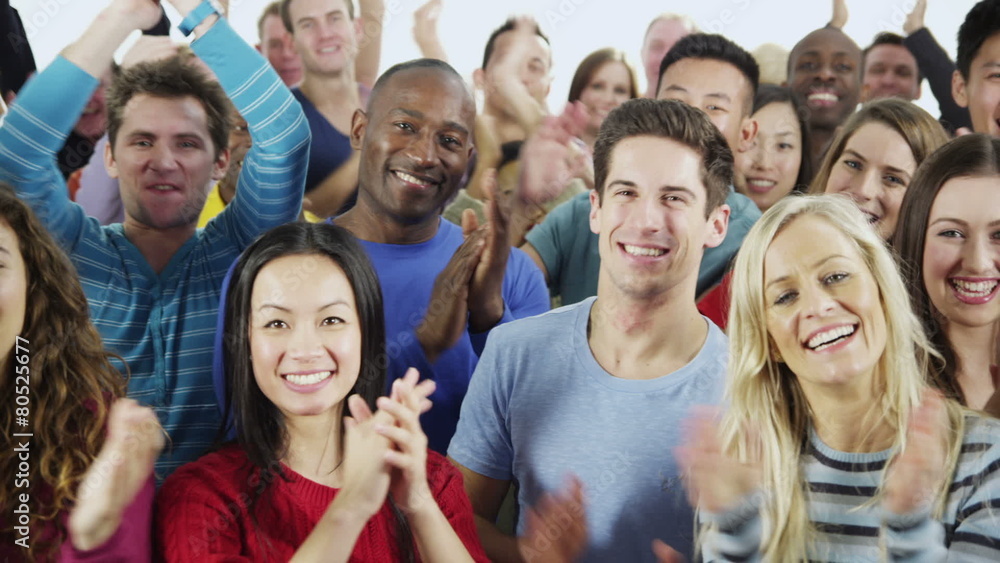 Happy, diverse group in casual clothing smiling and clapping