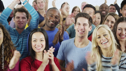 Happy, diverse group in casual clothing smiling and clapping photo