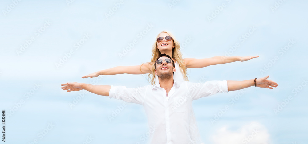 couple holding hands up at sea side
