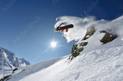 Snowboarder pulls off a “Method Air” in the backcountry © topshots