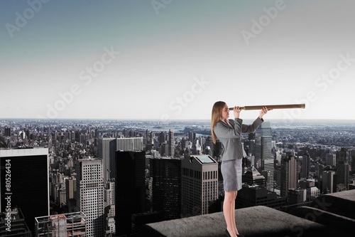 Composite image of businesswoman looking through a telescope