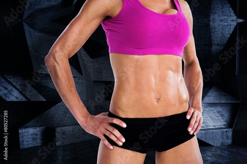 Female bodybuilder posing with hands on hips