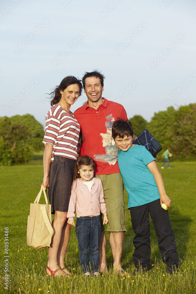 A family, two parents and two children outdoors in the summer having a picnic. A family, two parents and two children outdoors in the summer having a picnic.