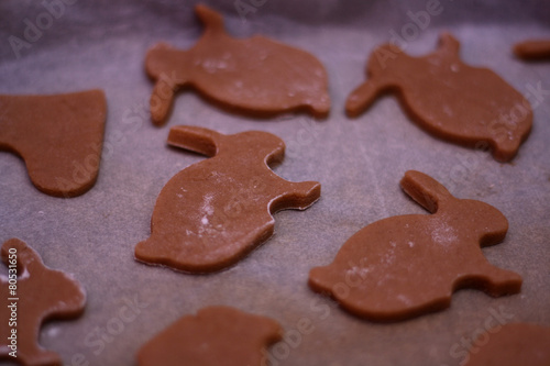 Bunny shaped gingerbread cookies in an oven pan, before baking.