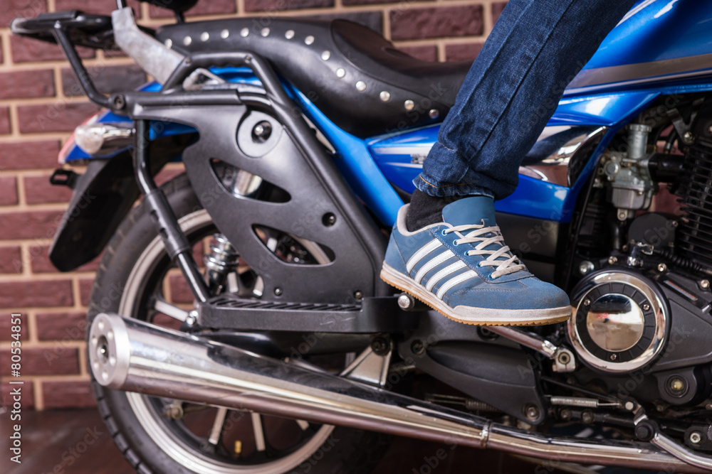 Person Standing on Foot Pegs of Cruiser Motorcycle