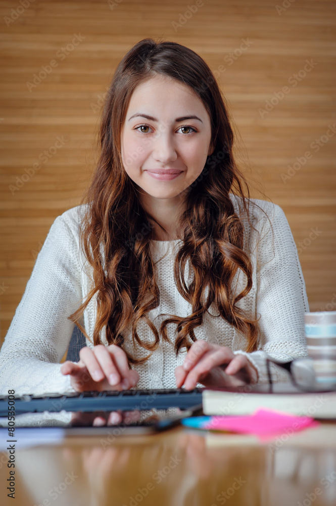 Brunette in the office working on the computer Brunette in the office working on the computer