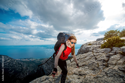 Young mountain climber on the top of island