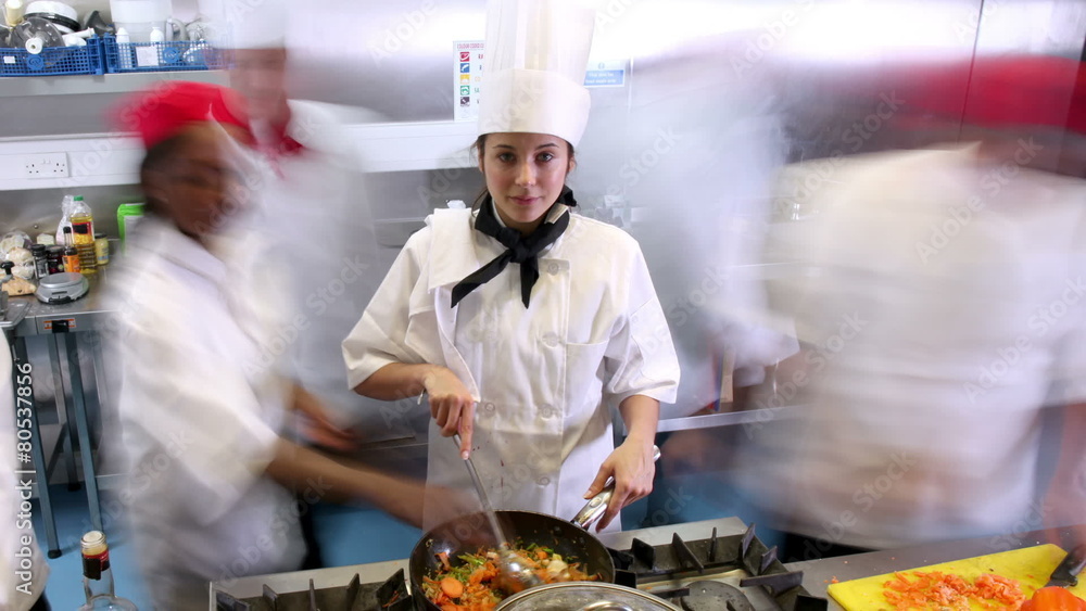 Time lapse of busy team of chefs preparing food in a commercial kitchen Time lapse of busy team of chefs preparing food in a commercial kitchen