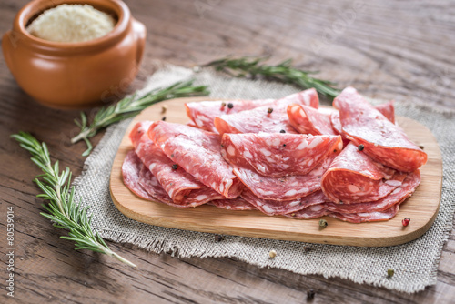 Slices of salami on the wooden board