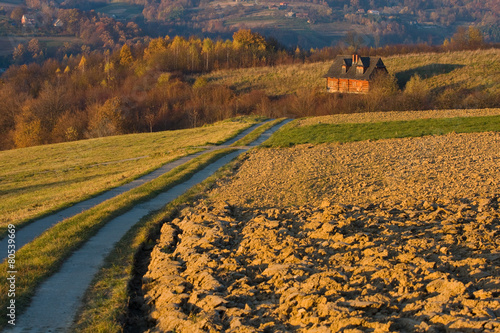 Cottage house in autumn fields, Poland.
