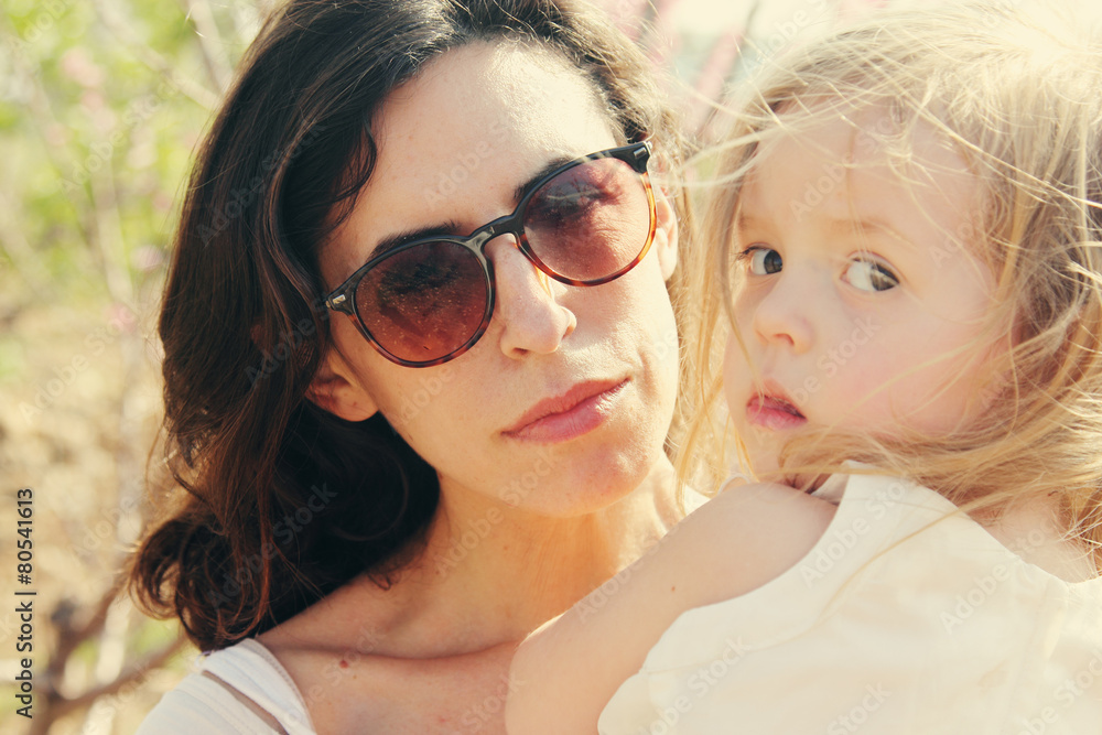 Portrait of happy loving mother and her daughter outdoors