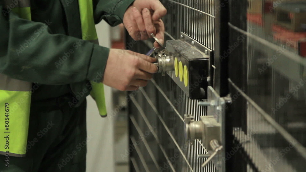 Worker opening security door Worker opening security door