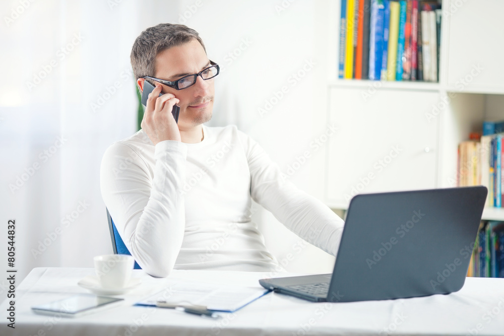 Portrait of young businessman working at home Portrait of young businessman working at home