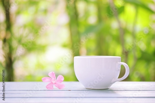 White coffee cup and frangipani flower