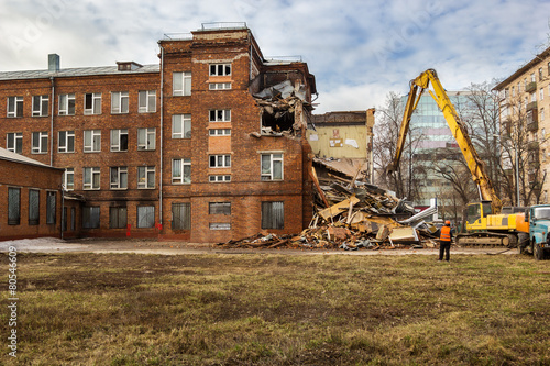 excavator demolishes old school building