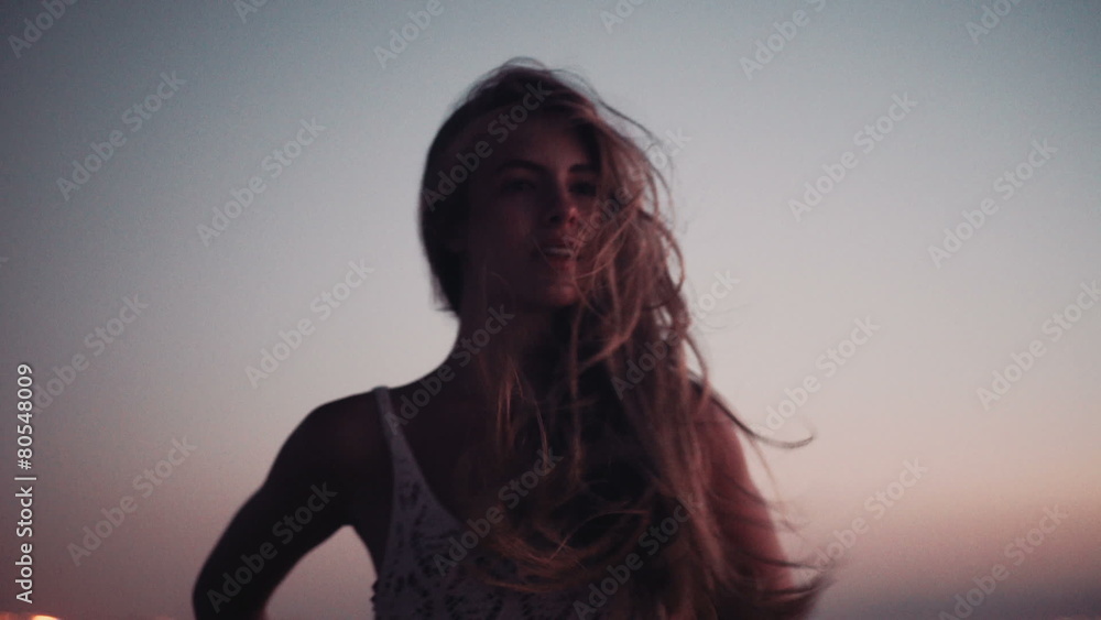 Girl watching the sea on the beach at dusk Girl watching the sea on the beach at dusk