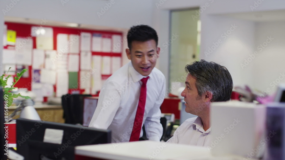 Attractive diverse business group working together in a busy modern office Attractive diverse business group working together in a busy modern office