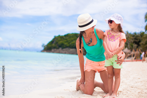 Hppy family of mom and girl during summer beach vacation