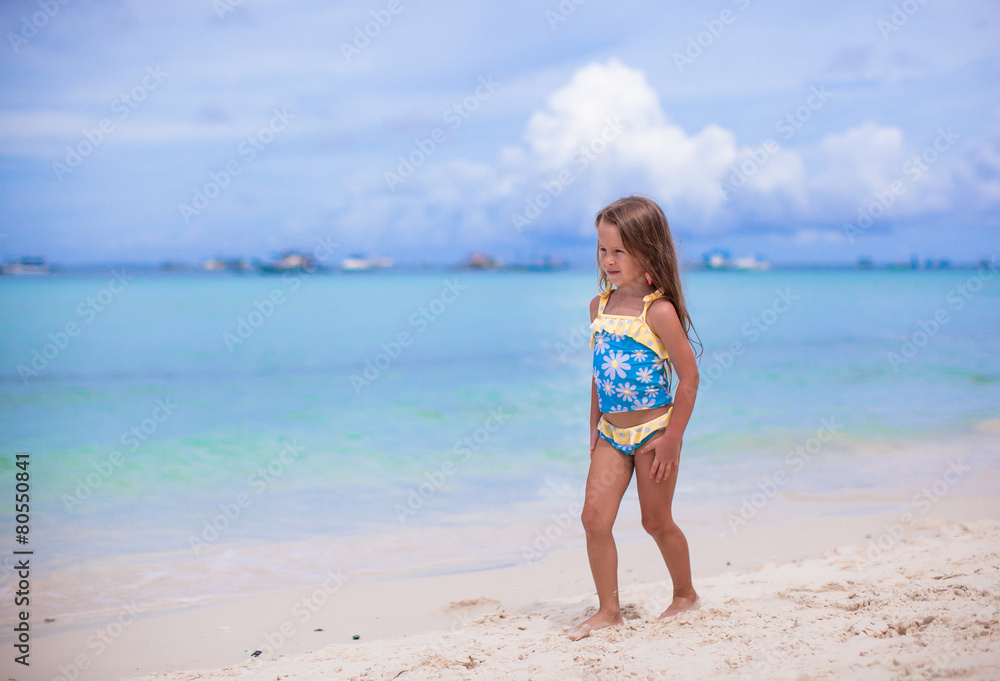 Adorable little girl have fun at tropical beach during vacation Adorable little girl have fun at tropical beach during vacation