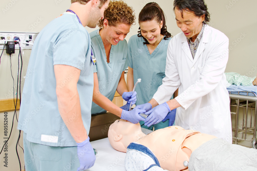 Medical staff practicing intubating mannequin Medical staff practicing intubating mannequin