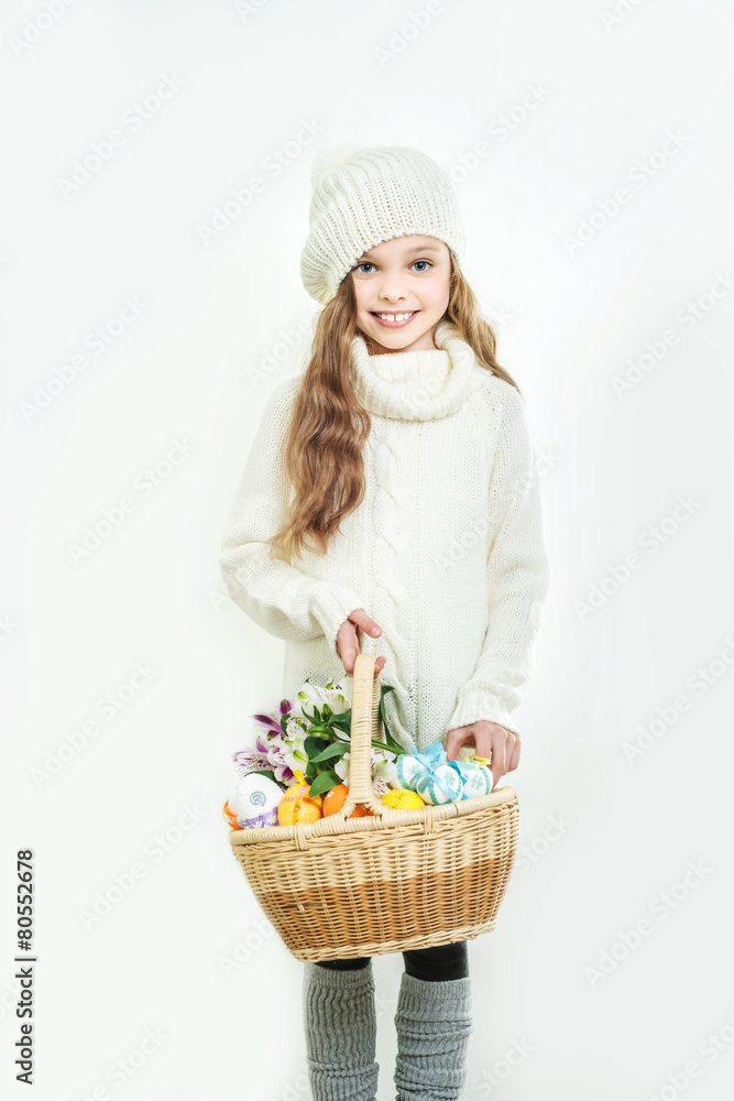 Smiling little girl with basket full of colorful easter eggs Smiling little girl with basket full of colorful easter eggs