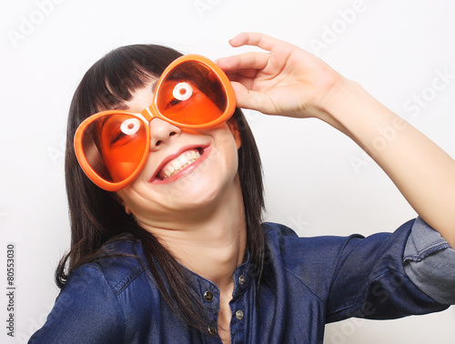 young happy woman with big orange sunglasses
