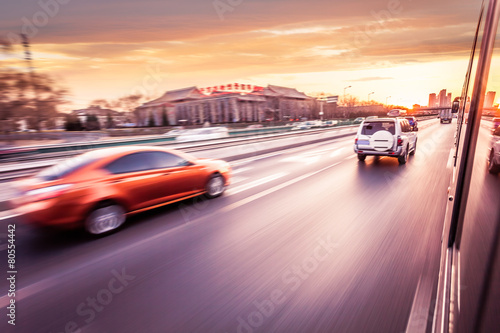 Car driving on freeway at sunset, motion blur © 06photo