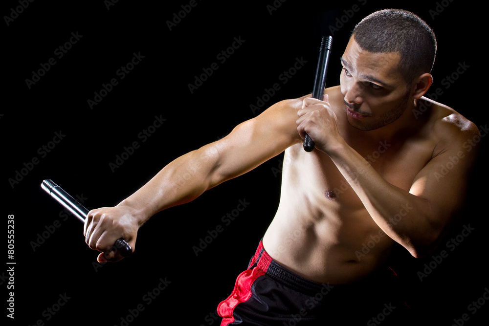 man demonstrating Filipino stick fighting martial arts StockFoto Adobe Stock