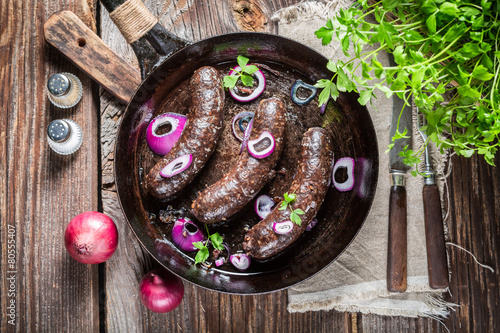 Hot black pudding with onion and parsley photo