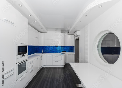 Specious modern white blue interior kitchen-dining room 