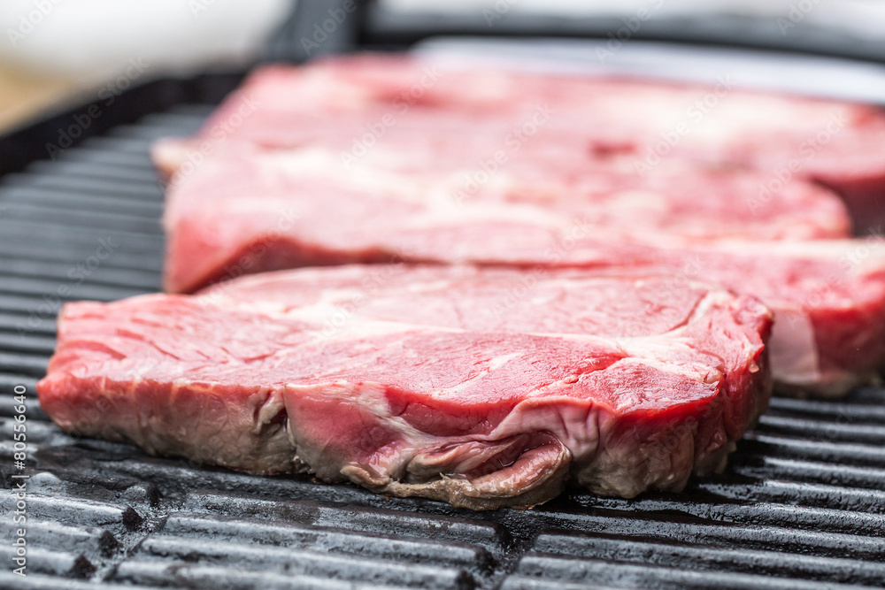 Fresh beef steaks on grill or BBQ Fresh beef steaks on grill or BBQ