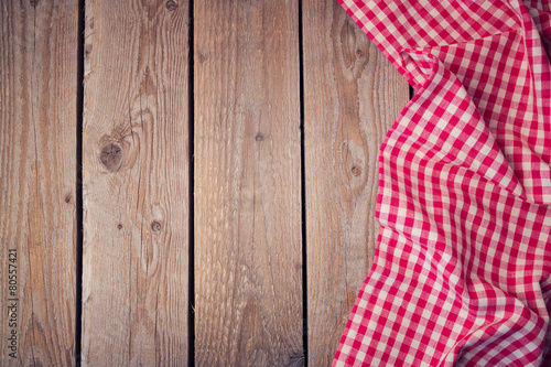 Wooden old table with checked tablecloth. View from above