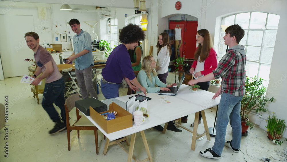 Diverse group of young students working together on a project 