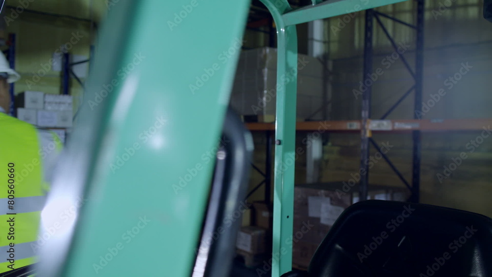 A female forklift truck driver arrives on shift in a factory A female forklift truck driver arrives on shift in a factory
