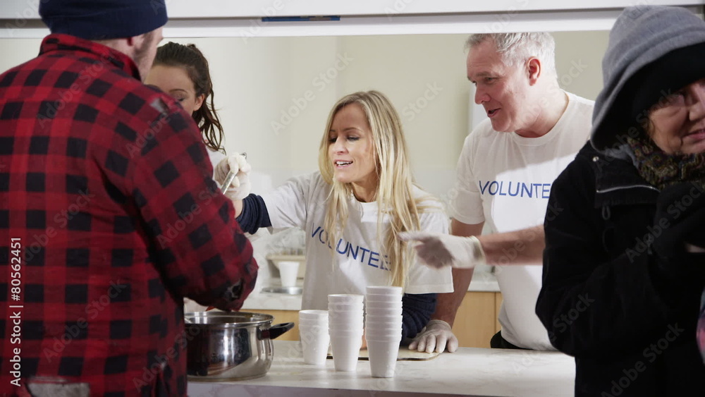 Soup kitchen volunteers help to feed the homeless Soup kitchen volunteers help to feed the homeless