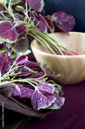 red spinach with wooden bowl