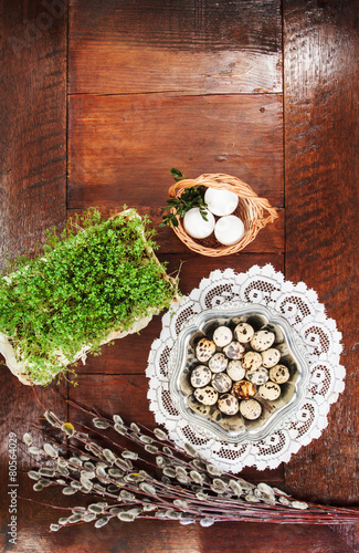 Easter composition of catkins and eggs on wooden table