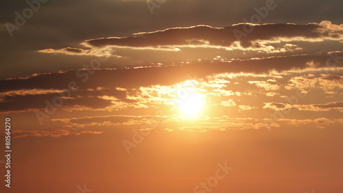 Time lapse cloudscape with the sun setting over the horizon