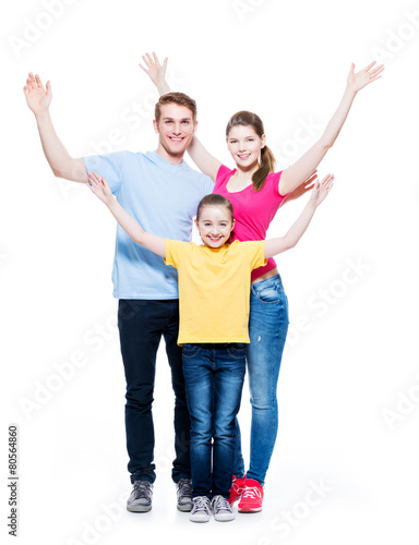 Cheerful family with child raised hands up.