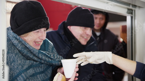 Soup kitchen volunteers help to feed the homeless
