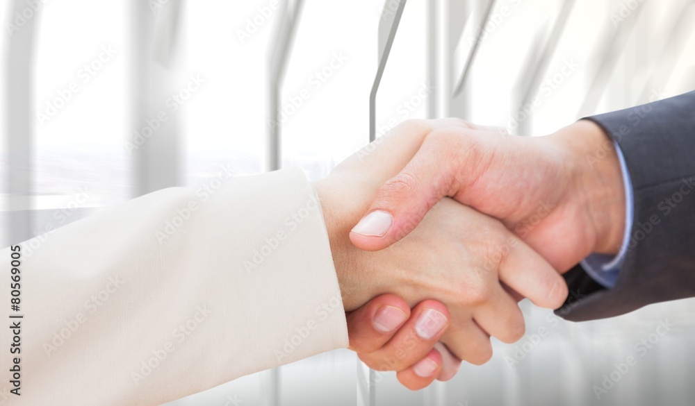 Composite image of close up on partners shaking hands Composite image of close up on partners shaking hands