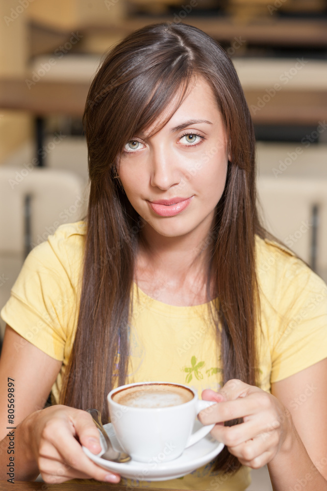 Young beautiful girl across table with cup Young beautiful girl across table with cup