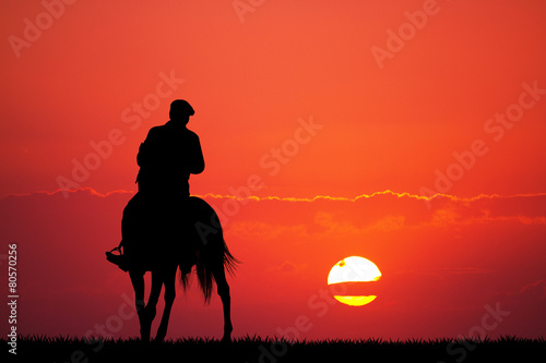 man on horse at sunset