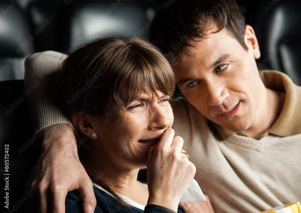 Fototapeta premium Man Comforting Woman Crying While Watching Movie