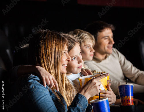 Family Of Four Watching Movie In Theater