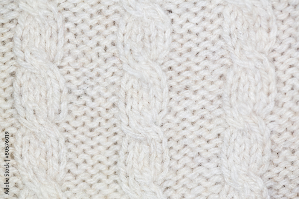 Knitting pattern from gray woolen warm soft yarn for background Knitting pattern from gray woolen warm soft yarn for background