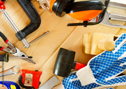 Many working tools on a wooden background.