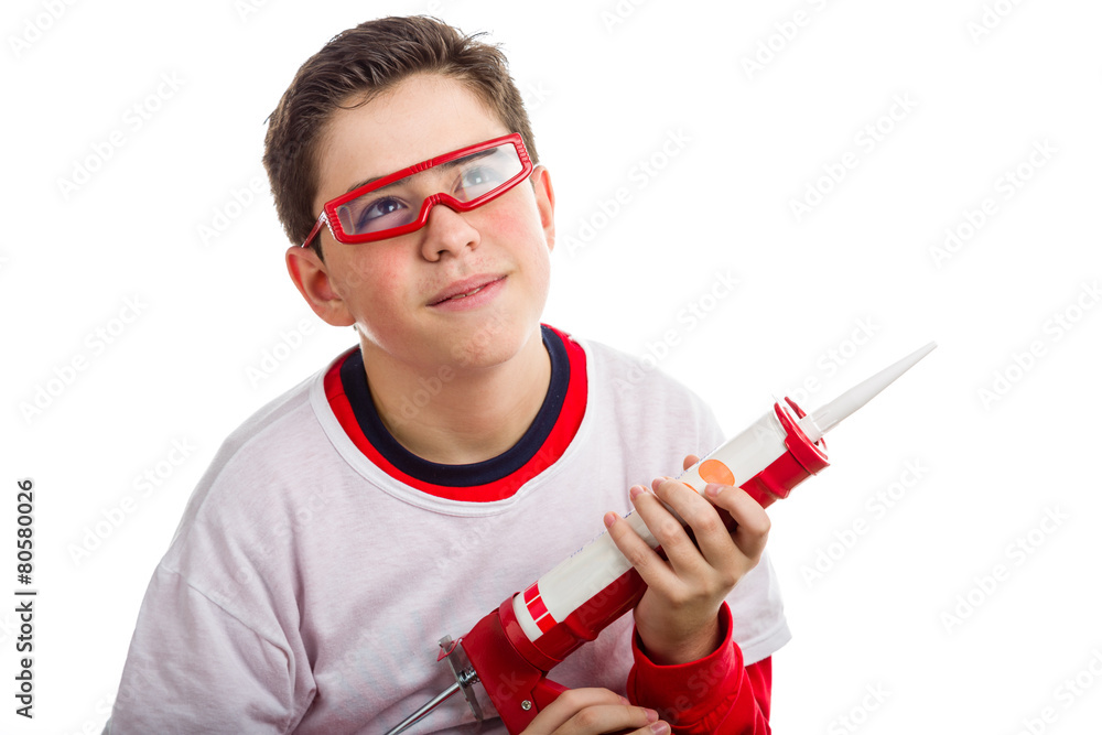 Boy wearing red goggles and holding a caulking gun Boy wearing red goggles and holding a caulking gun
