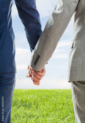 close up of male gay couple holding hands