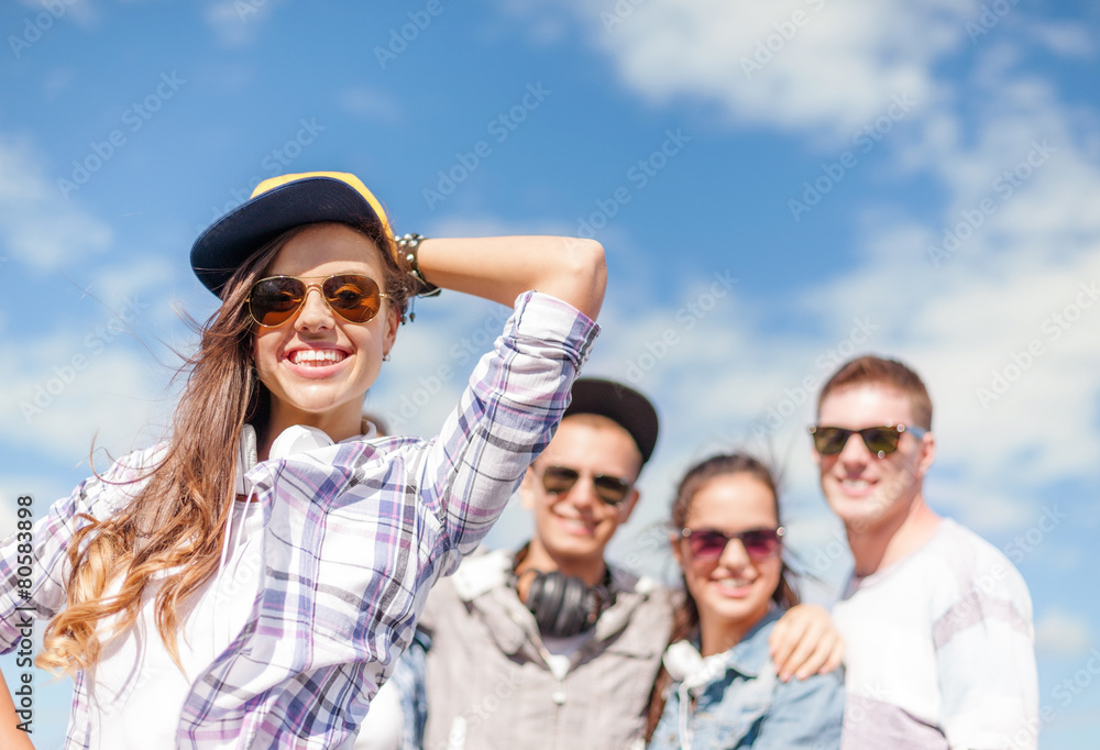 teenage girl with headphones and friends outside teenage girl with headphones and friends outside